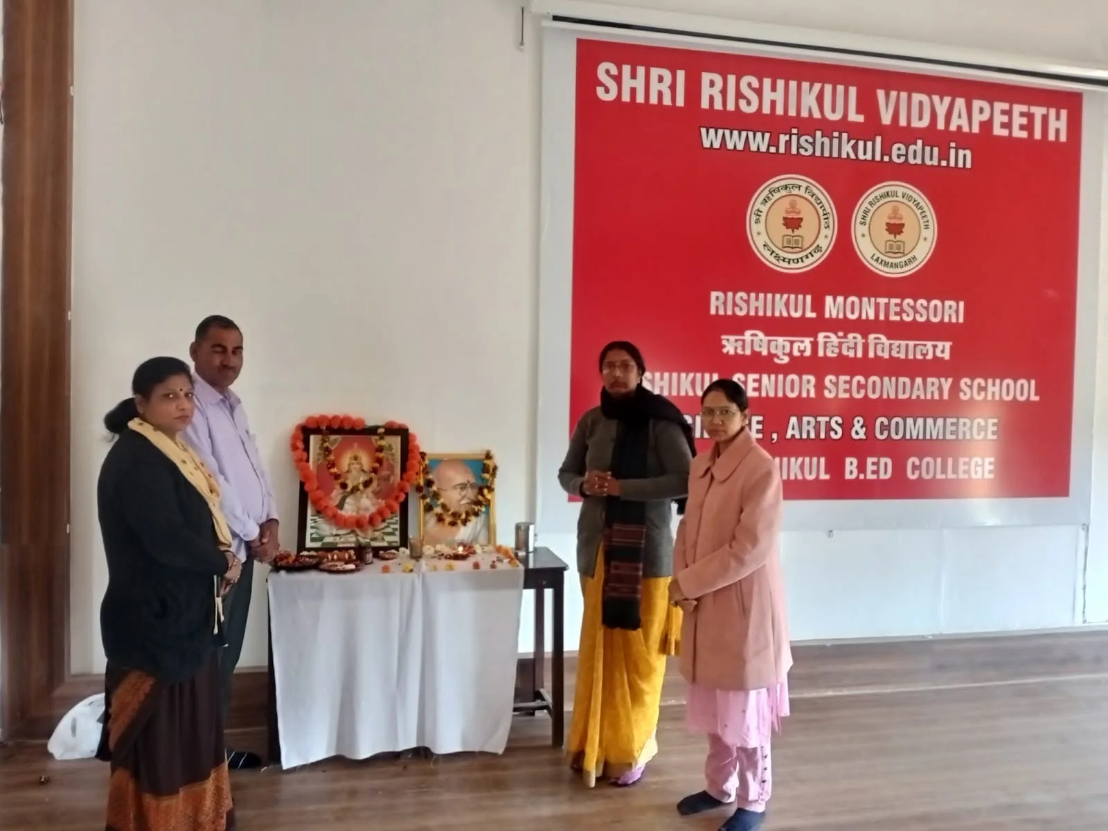 Staff at the lamp-lighting that opens a school function