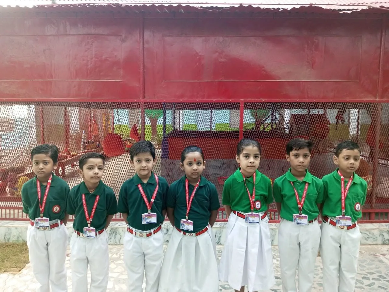 Pupils in green house uniform in the courtyard